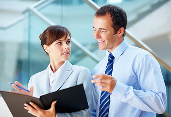 Image showing Business people, documents and advice with folder, planning budget and financial report in lobby. Corporate manager, woman and teamwork with bookkeeping questions, job management or revenue proposal