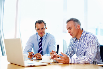 Image showing Business people, planning and teamwork on laptop for advice, support and strategy in a financial meeting. Professional manager, mature boss or men talking of revenue, sales or profit on a computer