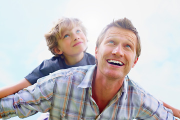 Image showing Father, son and smile outdoor with piggyback for bonding, relationship and freedom with blue sky in nature. Family, man and boy child with playing, care and love for excitement, peace and support