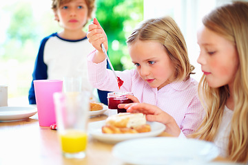 Image showing Breakfast, jam spread and child in morning, weekend and siblings for nutrition, orange juice and donut. Brother, sisters and enjoying food together for hunger, health and energy for good day