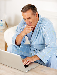 Image showing Sofa, morning and mature man on laptop, checking email, social media or streaming subscription. Internet search, couch and happy senior person on computer, website or networking in bathrobe in home.