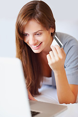 Image showing Home, woman and credit card with a laptop, online shopping and connection with a smile, buying and payment. Person, bedroom or girl with a computer, ecommerce and transaction with subscription or app