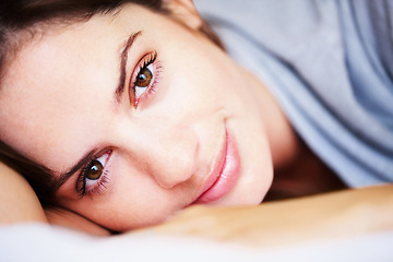 Image showing Rest, closeup and portrait of woman on bed for sleeping, dreaming and comfortable at home. Smile, morning and face of tired person in bedroom relaxing, nap and wake up for health, wellness and calm