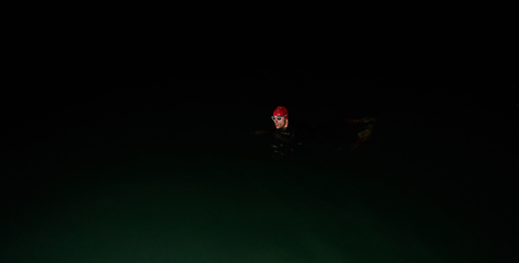 Image showing Authentic triathlete swimmer having a break during hard training on night