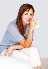 Image showing Happy, coffee and portrait of woman in home for relaxing, calm and breakfast on weekend. House, apartment and person smile with mug for warm beverage, tea and drinking caffeine in bedroom in morning
