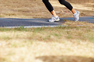 Image showing Running, park and shoes of woman in nature for fitness, speed and cardio challenge. Wellness, sports and workout with female runner training in outdoor path for exercise, fast and performance