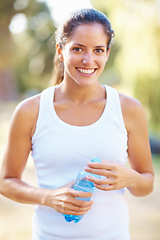 Image showing Portrait, fitness or happy woman with water in a park for running, wellness or training with bokeh. Sports, liquid and face of female runner in nature for exercise with positive mindset and energy