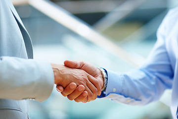 Image showing Corporate people, shaking hands and welcome to meeting, partnership and introduction for deal at law firm in lobby. Closeup of business lawyer or clients handshake for success, support and consulting