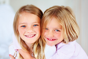 Image showing Portrait, sisters and hug indoors with love for relax wellness, happiness and sibling support in home. Children, girls and smile face for fun morning in embrace, family and bonding for care in house