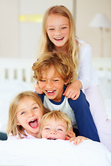 Image showing Portrait, laughing or crazy with brother and sister sibling children on a bed in their home together. Family, funny or silly with young boy and girl kids in the bedroom of an apartment on the weekend