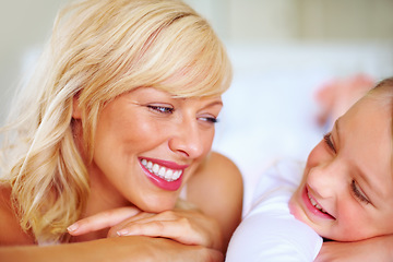 Image showing Happy, conversation and mother with child on bed for bonding, relaxing and spending time together. Smile, love and young mom chilling and resting with girl kid from Australia in bedroom of house.