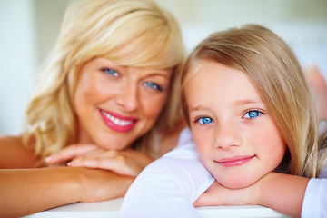 Image showing Happy, portrait and mother with girl on bed for bonding, relaxing and spending time together. Smile, love and young mom chilling and resting with kid or child from Australia in bedroom of family home