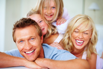 Image showing Portrait, love and a family laughing on a bed together while in the home on a weekend morning. Face, smile and a funny father, mother and children in the bedroom of an apartment to relax for bonding