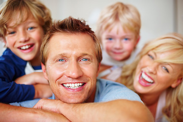 Image showing Portrait, smile and a happy family on a bed together while in the home on a weekend morning. Face, love or funny with a dad, mom and kids laughing in the bedroom of an apartment to relax for bonding