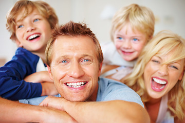 Image showing Portrait, smile and a crazy family on a bed together while in their home on a weekend morning. Face, love or funny with a father, mother and kids in the bedroom of an apartment to relax for bonding