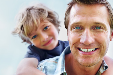 Image showing Father, son and portrait or smile with piggyback for bonding, relationship and freedom with blue sky in nature. Family, man and boy child with playing, care and love for happiness, peace and support