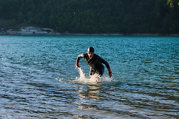 Image showing Triathlon athlete starting swimming training on lake