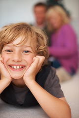 Image showing Portrait, boy and relaxing with parents for holiday, happy and excited on floor. Bonding together, smile and family home for festive season, cheerful and joy in house, childhood memories or indoor