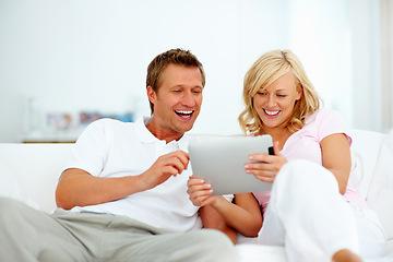 Image showing Couple, tablet and smile on sofa for social media, download funny movies and streaming internet show. Happy man, woman and laugh for digital technology, online shopping and connection in living room