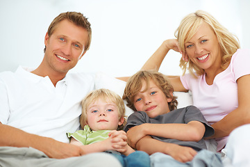 Image showing Portrait, smile and family in home together, bonding and relax, care or support on living room sofa. Happy face, parents and children in house lounge on couch with love for kids, father and mother