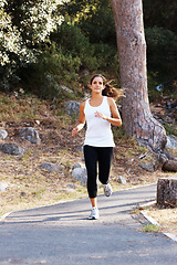 Image showing Running, health and path with woman in nature for fitness, speed and cardio challenge. Wellness, sports and workout with female runner training in road outdoor for exercise, fast and performance