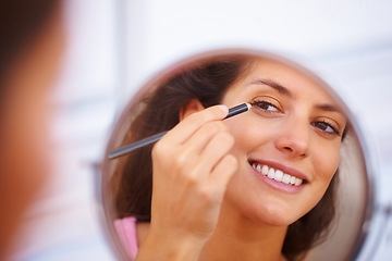 Image showing Mirror, makeup and happy woman with eyeliner, pencil or application in a home bathroom with morning routine. Face, beauty and female person with eye, color or shape, aesthetic or cosmetic treatment