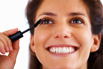 Image showing Woman, face and mascara with smile for beauty, cosmetics and facial skincare with eyelash in home. Person, happy and eyes application with product or grooming for makeup, cosmetology and aesthetic