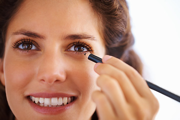 Image showing Woman, face and eyeliner with smile for beauty, cosmetics and facial skincare with pride in home. Person, happy or eye application with grooming product or pencil for makeup, cosmetology or aesthetic