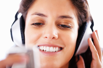 Image showing Headphones, music player and woman face listening to playlist track, audio podcast or wellness sound. Closeup, tech and relax girl reading, scroll or choice for media, song or radio streaming app