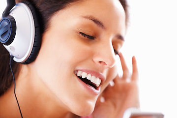Image showing Music headphones, singing and woman face listening to playlist track, audio podcast or wellness sound. Freedom, eyes closed and closeup girl, student or singer streaming media, song or radio app
