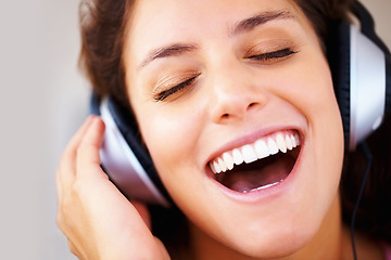 Image showing Music, headphones and happy woman singing in house with freedom, good mood or vibes. Earphones, karaoke and face of person with eyes closed, smile or energy while listening to radio, audio or podcast