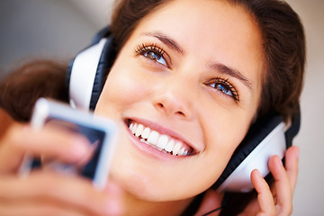 Image showing Smile, headphones and closeup of young woman listening to music, playlist or radio at home. Happy, technology and face of female person from Canada relax and streaming song or album in her apartment.