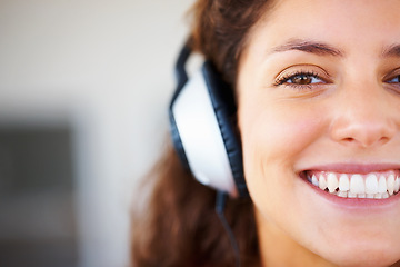 Image showing Smile, headphones and half face of woman listening to music, playlist or radio at home. Happy, technology and portrait of female person from Canada relax and streaming song or album in her apartment.