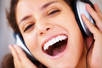 Image showing Excited, headphones and closeup of young woman listening to music, playlist or radio at home. Happy, technology and face of female person from Canada relax and streaming song or album in apartment.