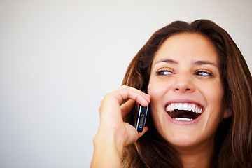 Image showing Happy, phone call and young woman laughing at comic, funny or comedy joke in conversation in a studio. Smile, technology and person from Canada on mobile discussion with cellphone by gray background.