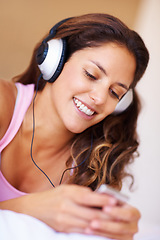 Image showing Smile, headphones and young woman listening to music, playlist or radio at home for entertainment. Happy, technology and female person from Canada relax and streaming song or album in her apartment.