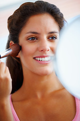 Image showing Woman, face and makeup brush with smile for beauty, cosmetics and facial skincare with mirror in home. Person, happy and glow application with product and hand for wellness, cosmetology and aesthetic