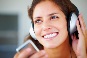 Image showing Happy, headphones and closeup of young woman listening to music, playlist or radio at home. Smile, technology and face of female person from Canada relax and streaming song or album in her apartment.