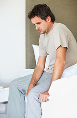 Image showing Thinking, sad and man in bed in depression, anxiety or frustrated, lonely or mental health crisis in home. Tired, fatigue and person in bedroom stress, insomnia challenge and wake up in the morning