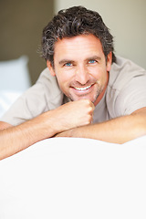 Image showing Smile, relax and portrait of mature man in bed in morning after nap, break or comfortable sleep at home. Happy, idea and male person from Canada wake up in bedroom for rest on cozy day in apartment.