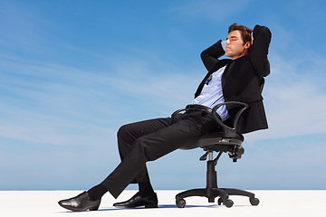 Image showing Business man, relax and outdoor nap of a corporate professional in a chair with peace from success. Worker, calm and young male employee and suit with mockup space and blue sky with job and career