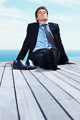 Image showing Business man, outdoor and relax on vacation of a corporate professional on holiday with peace on deck. Worker, male employee and suit by sea with calm and blue sky with job and career by ocean