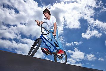 Image showing Ride, ramp and man with bike at park, event or competition for sport with risk, energy and freedom. Mockup, space or person in performance of stunt trick on bicycle for fun in summer with adventure