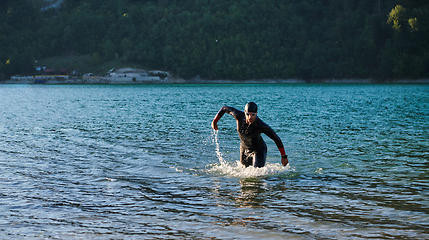 Image showing Triathlon athlete starting swimming training on lake