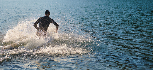 Image showing Triathlon athlete starting swimming training on lake