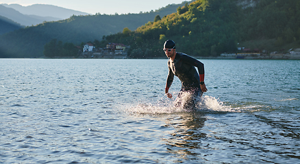 Image showing Triathlon athlete starting swimming training on lake