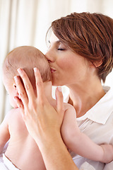 Image showing Mother, baby and kiss or love, care and relaxing or play, bonding and joy in parenthood. Mom, kid and motherhood or affection at home, connect and happy for child development, comfort and happiness