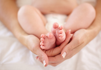 Image showing Woman, child and feet holding for love connection or childhood bonding, motherhood or newborn. Female person, infant and toes or care support for kid growth development, parent trust or nurture youth