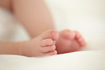 Image showing Child, newborn and feet or toes closeup or infant development, safety care or growth support. Baby, foot and soft skin asleep for healthy birth on blanket love or tiny legs or wellness, youth in home