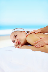 Image showing Woman, massage and muscle on bed in spa for health, wellness and recovery with rest, peace and quiet. Girl, mockup space and resort for rehabilitation, blue sky or physical therapy for body fatigue